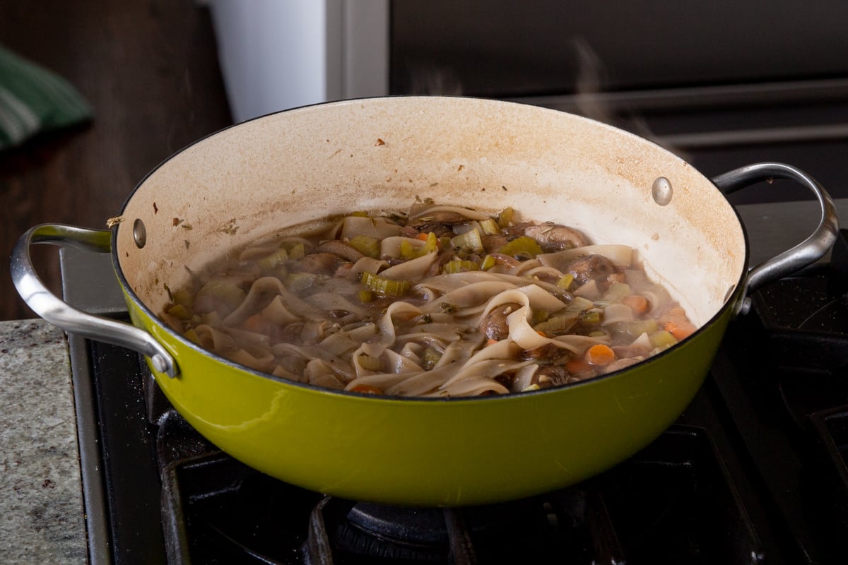 cooked mushroom noodle soup in the pan