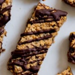 close-up of crunchy granola bars with chocolate topping on a white plate