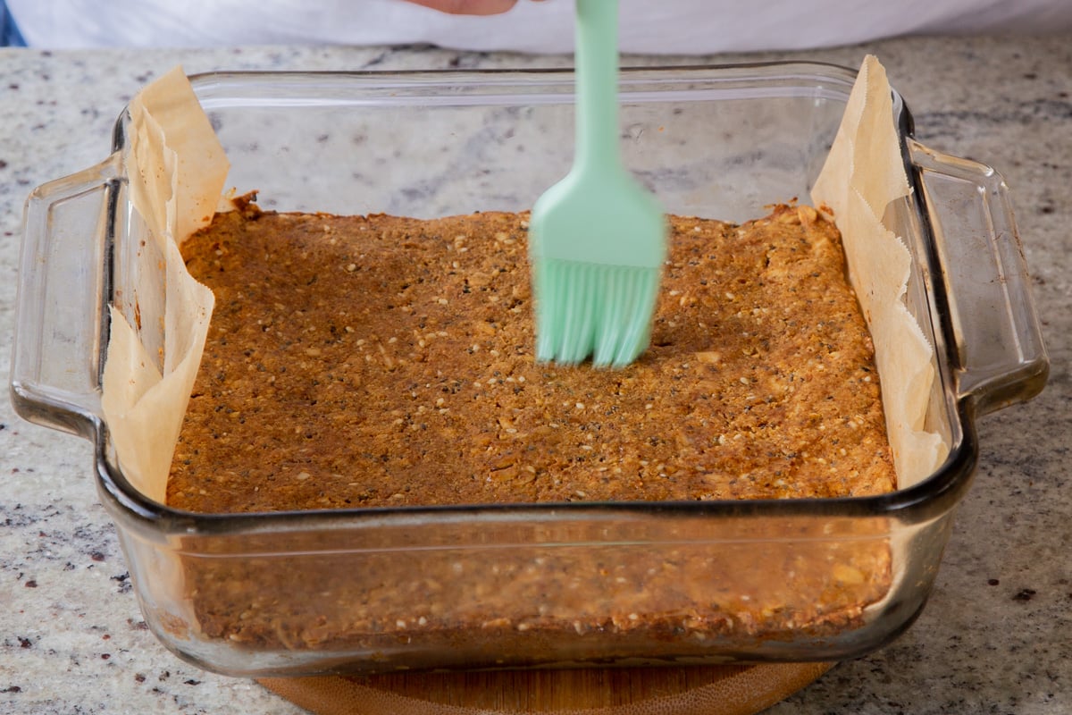 brushing oil onto baked savory granola bars