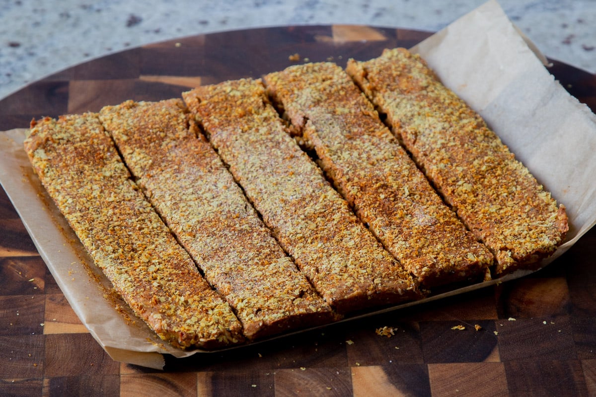savory granola bars on a cutting board after slicing
