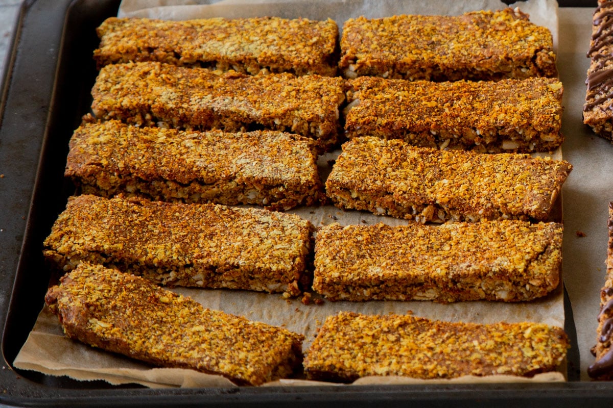 savory granola bars on a lined baking sheet before baking for extra crispness