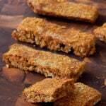 savory granola bars on a cutting board, one is broken in half so you can see the texture inside