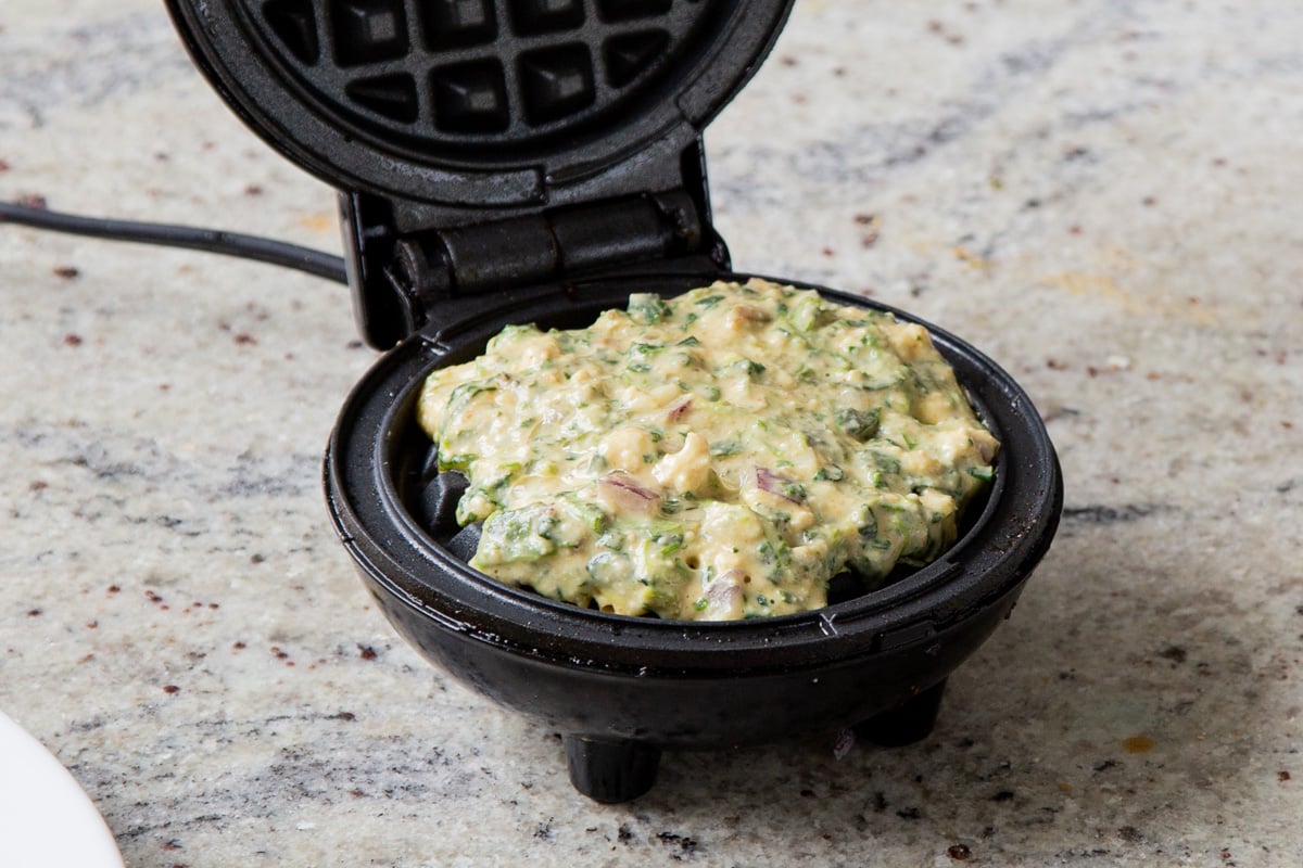 palak tofu waffle batter in the waffle iron
