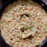 panful of Tuscan beans with a piece of flatbread dipped into it