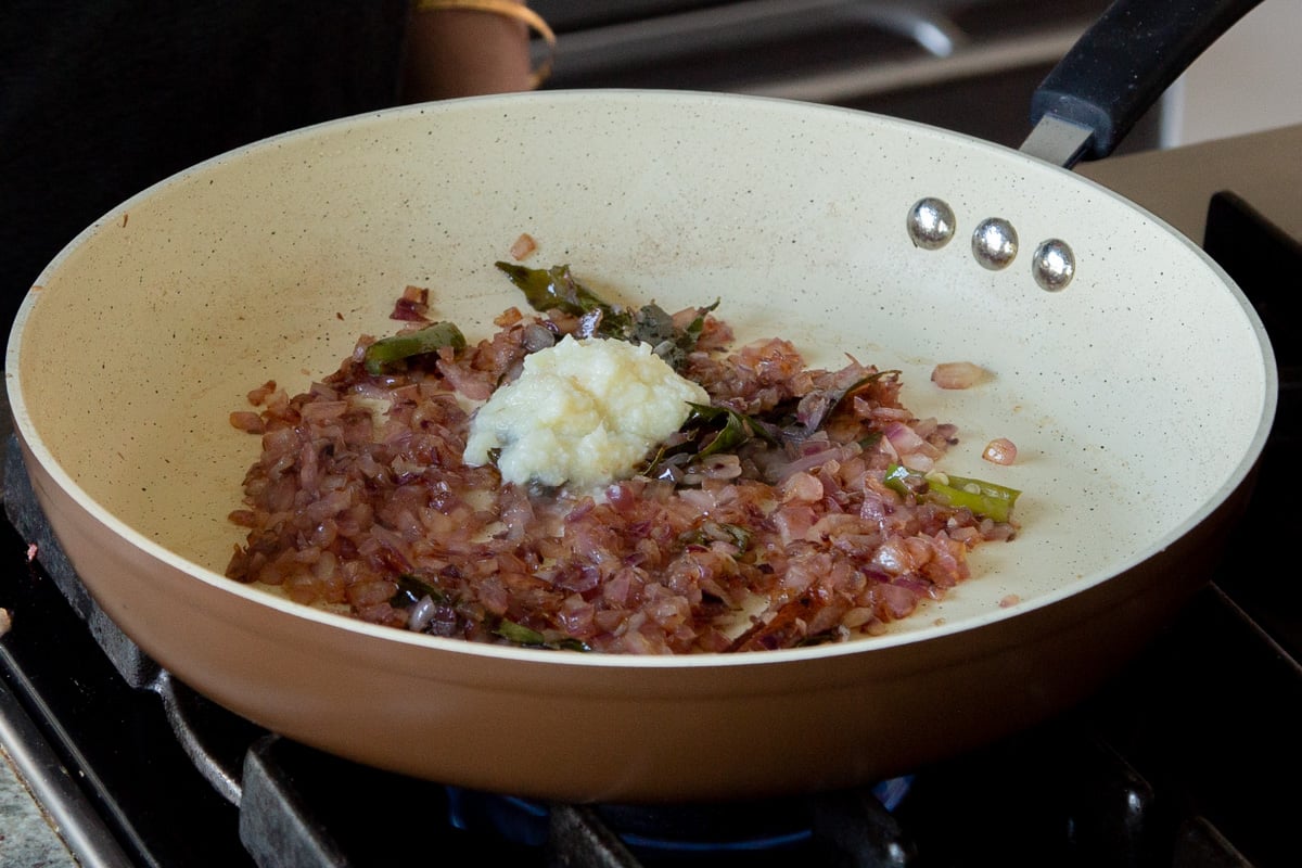 adding ginger-garlic paste to the pan