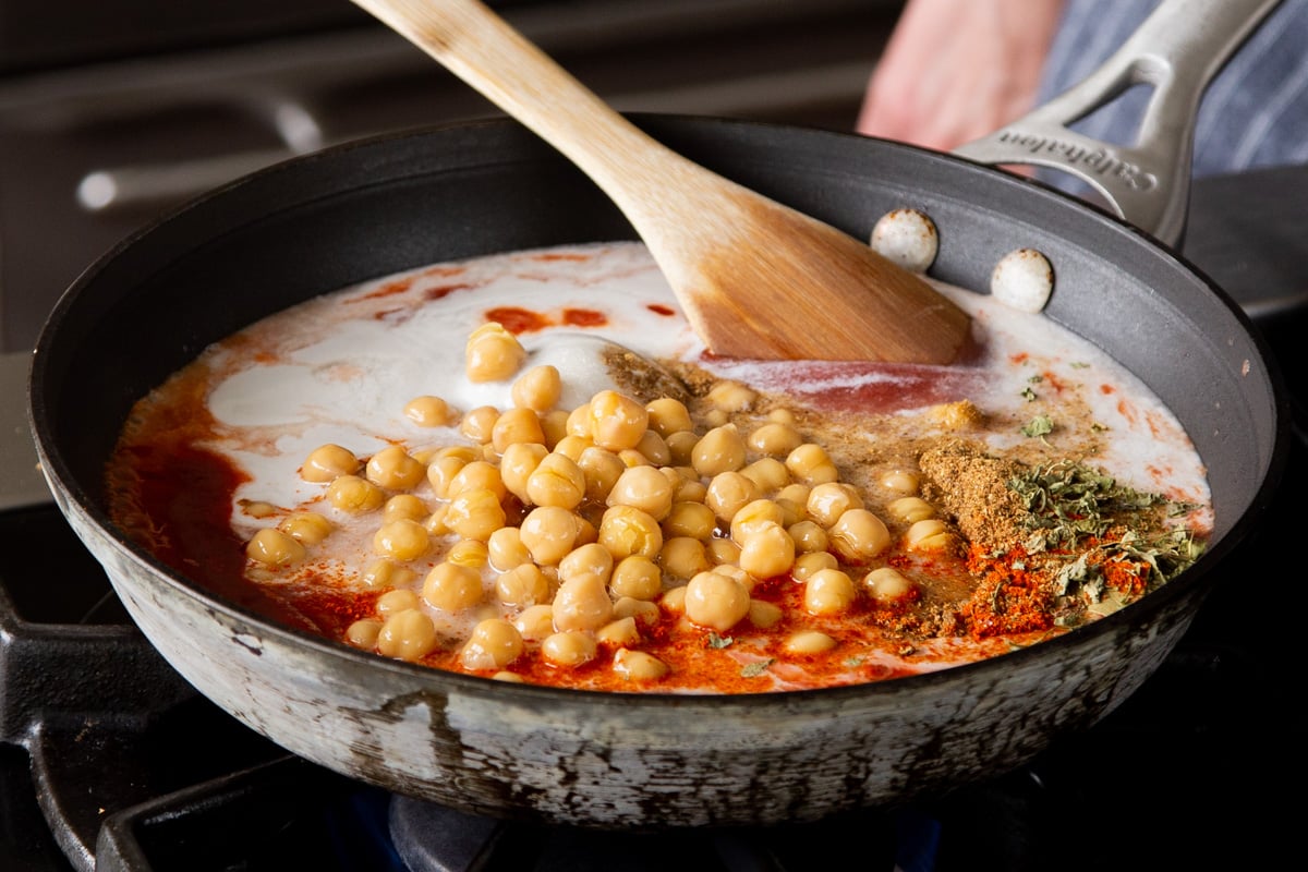 chickpeas in the skillet with the vegan butter chicken sauce ingredients