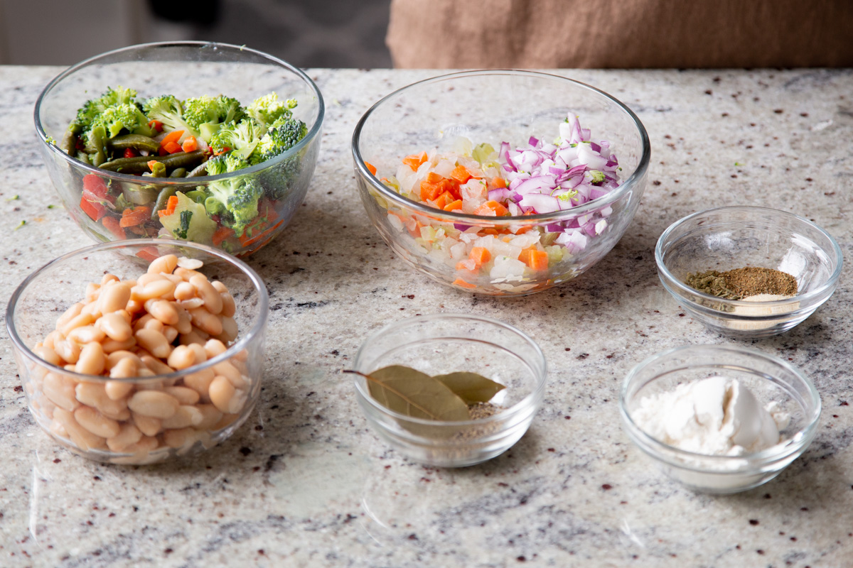 veggies, beans, and seasonings in bowls on the kitchen counter