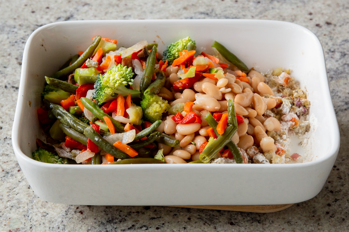 adding even more veggies to the pan