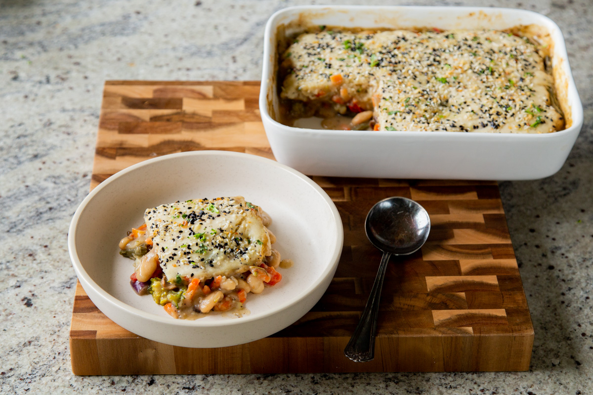 piece of everything bagel pot pie next to the baking pan