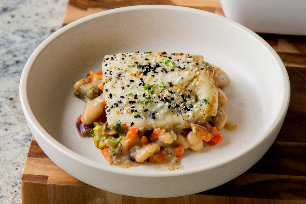 close-up of a slice of everything bagel pot pie with beans and veggies