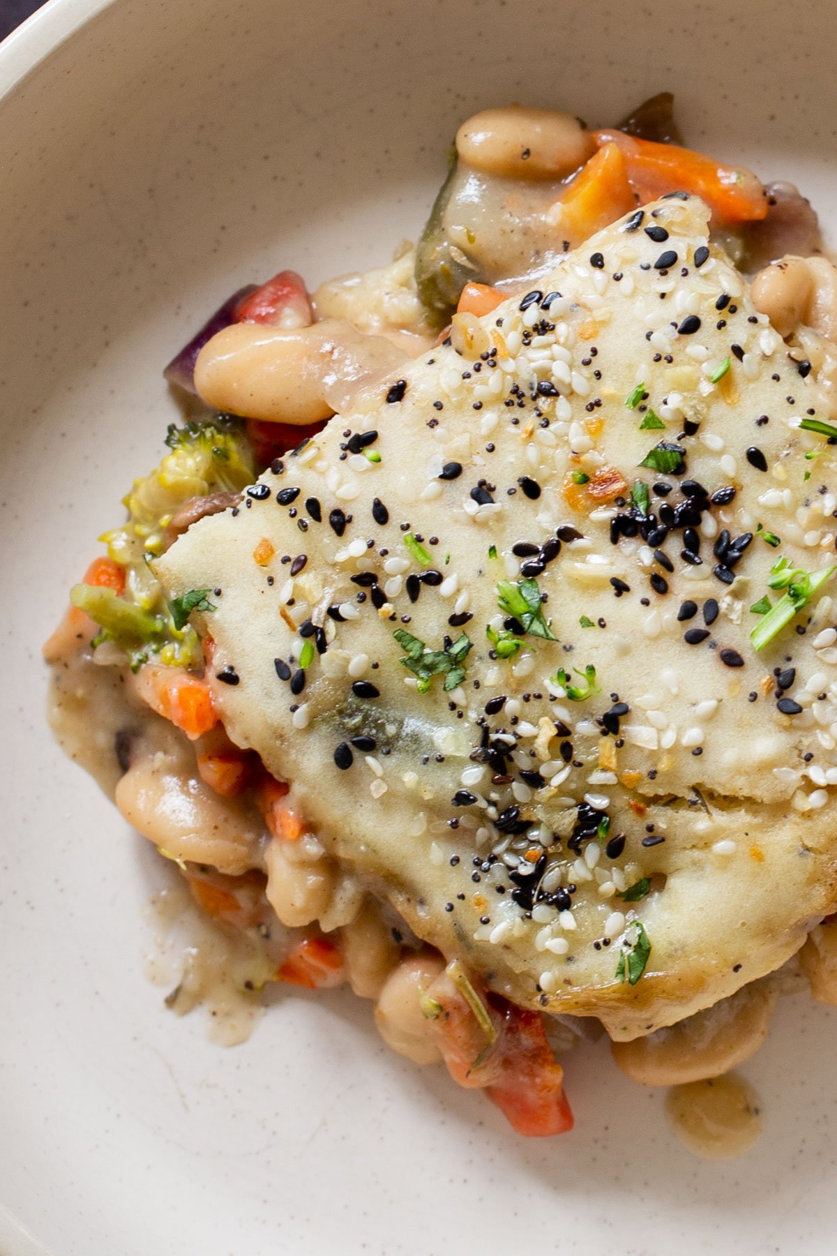close-up of everything bagel pot pie on a plate, so you can see the fillings
