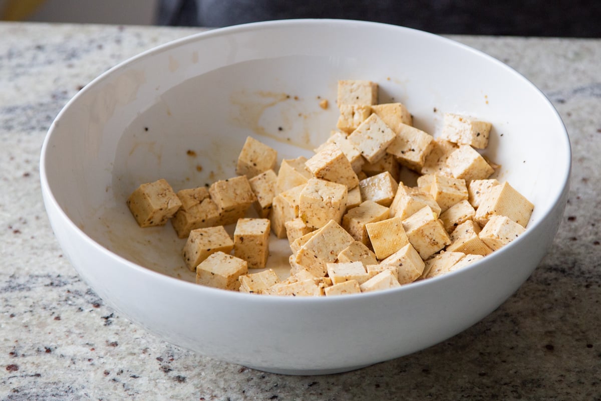 tofu in the bowl with soy sauce, after tossing