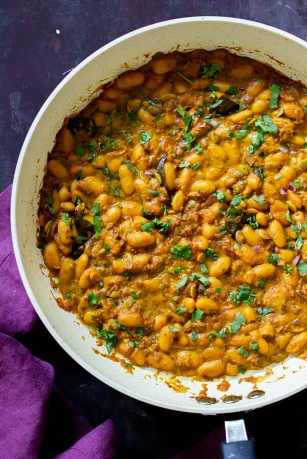 pan of spicy white bean stew with cilantro garnish