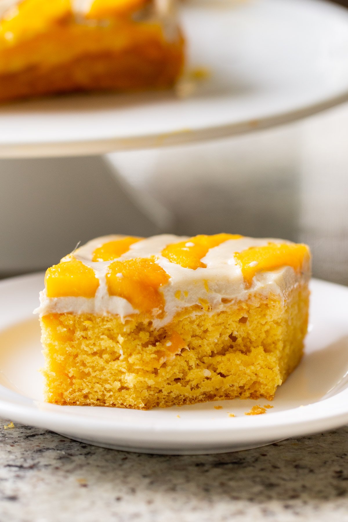 slice of mango tiramisu with a bite taken out, so you can see the inside texture