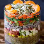 adding orange and seeds layer to the salad