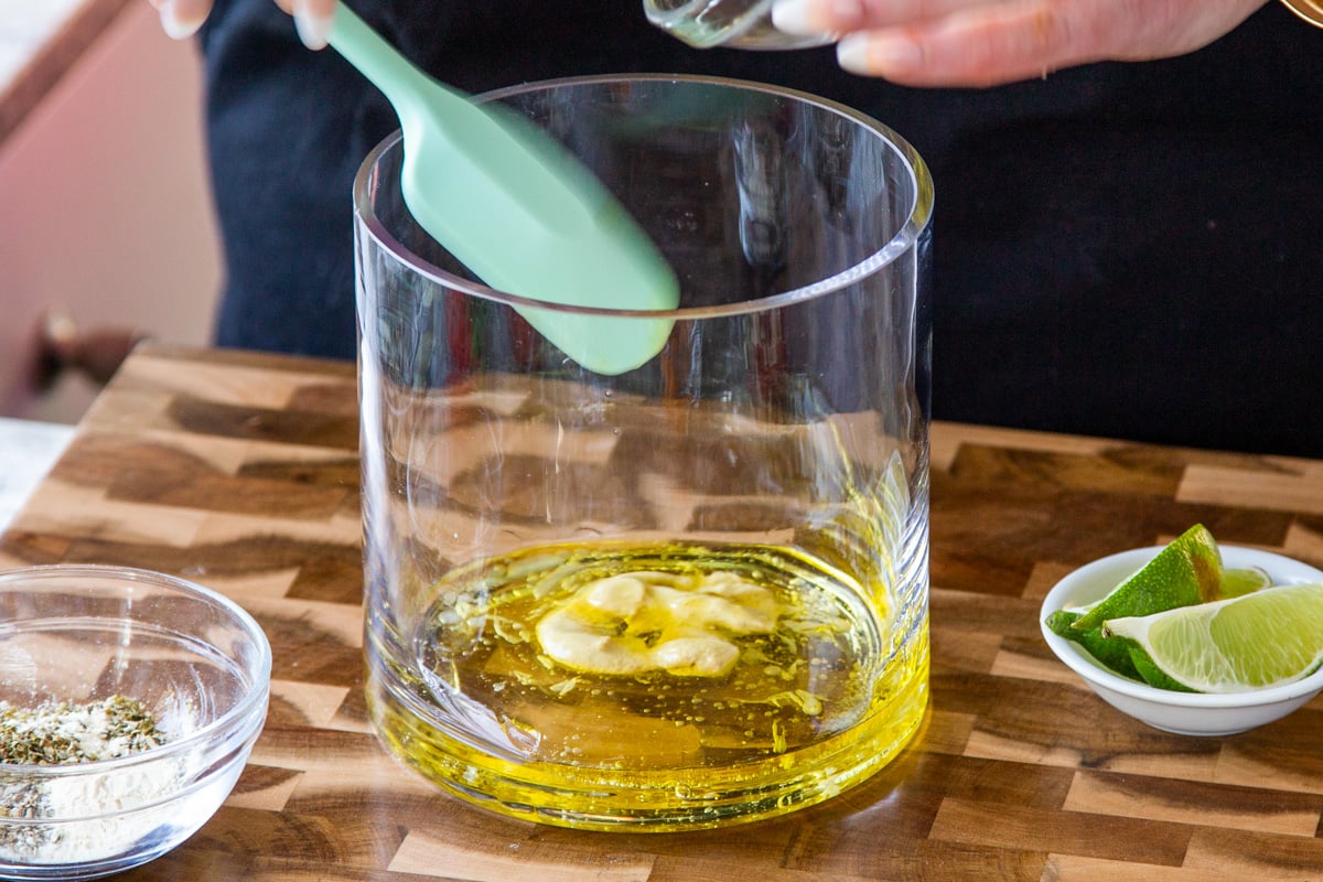 vinaigrette wet ingredients in the bottom of a large glass bowl