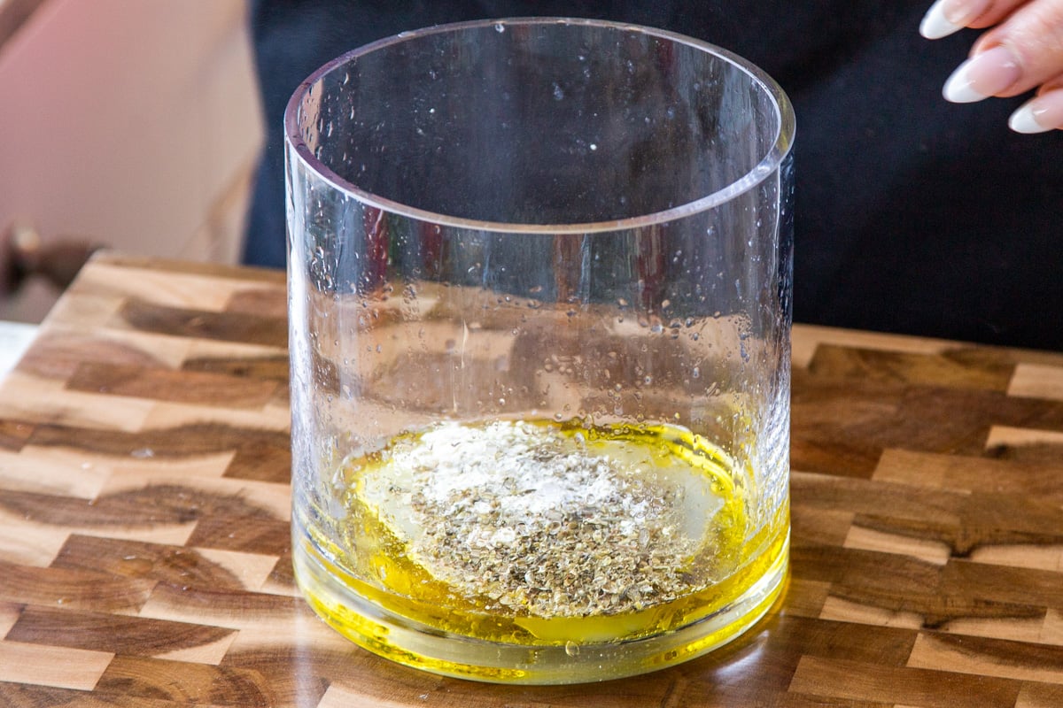 adding herbs and spices to the dressing ingredients