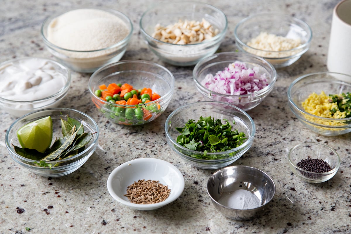 semolina flour, veggies, and seasonings in bowls on the kitchen counter