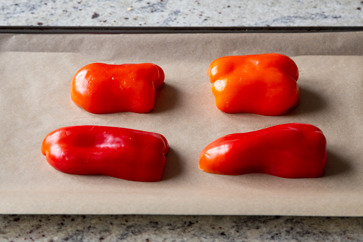 halved bell peppers on a lined baking sheet
