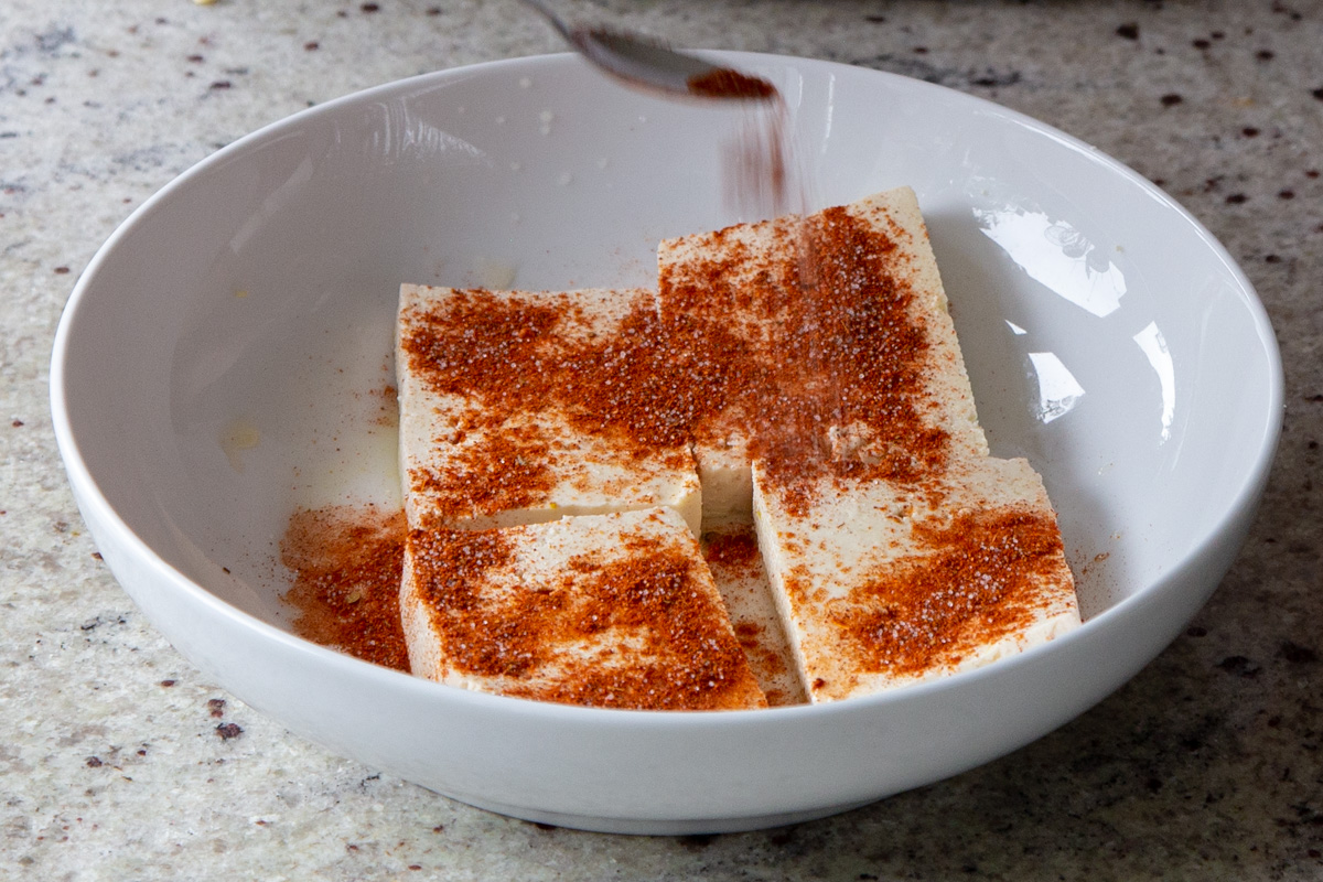 adding cajun spices to the tofu