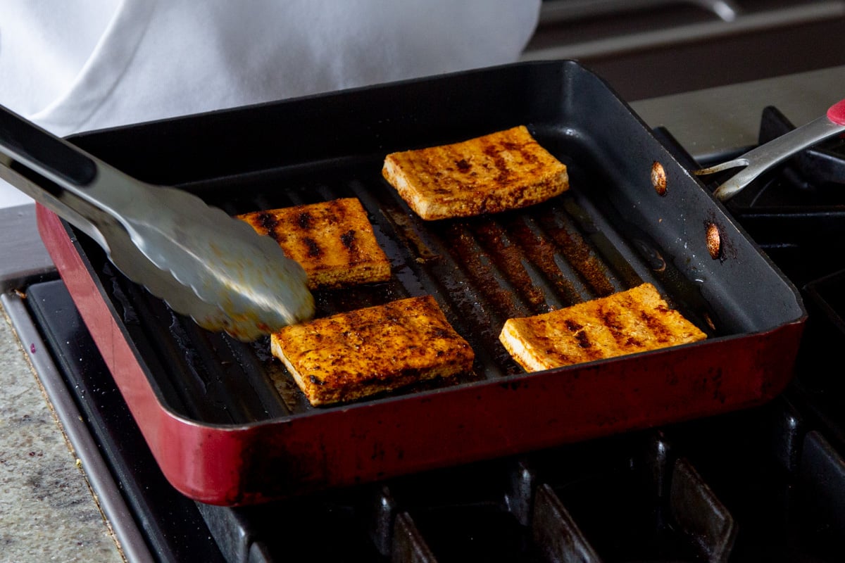 cajun tofu in a grill pan, after flipping