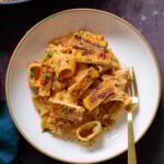 romesco pasta in a bowl with cajun tofu on top