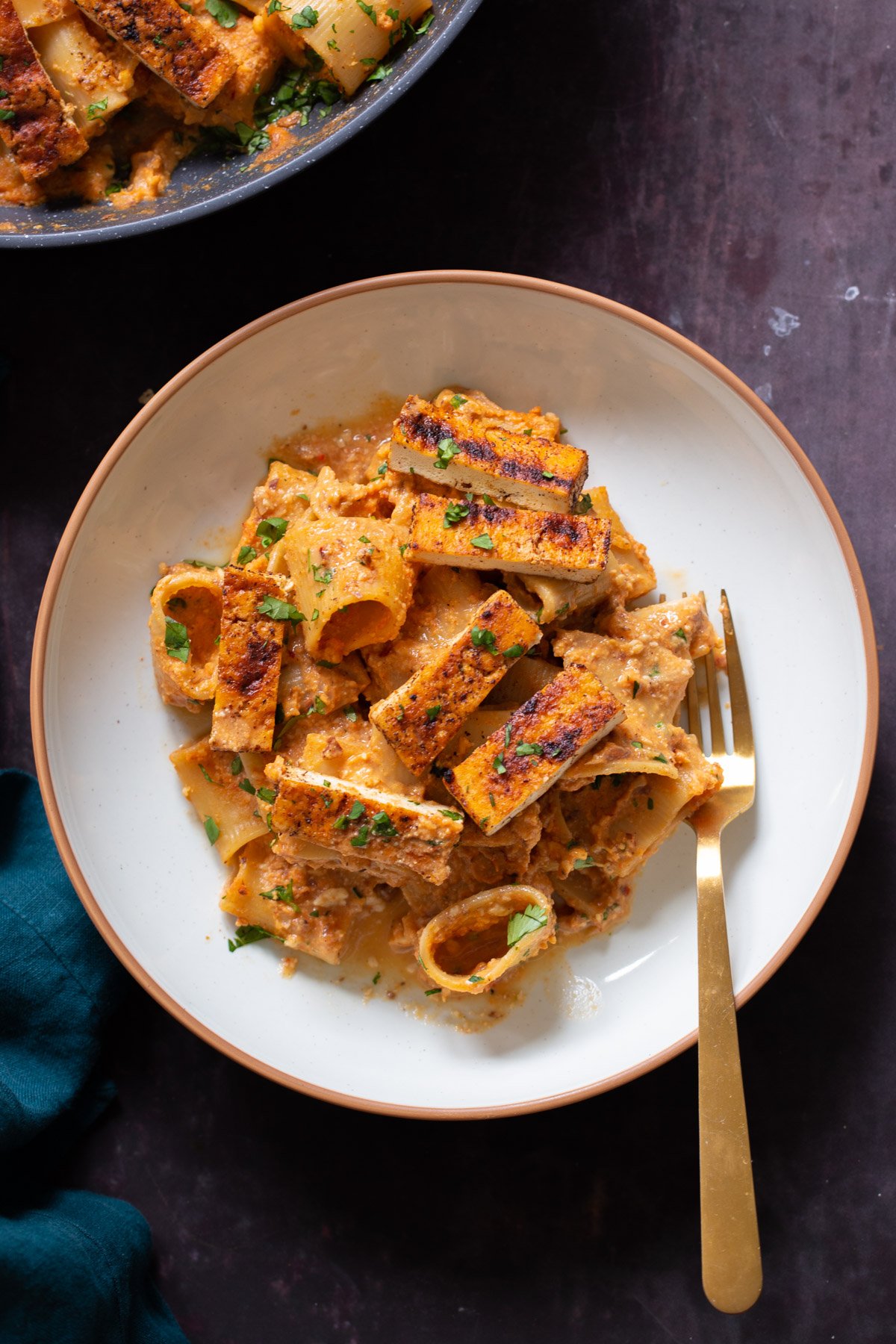 romesco pasta in a bowl with cajun tofu on top