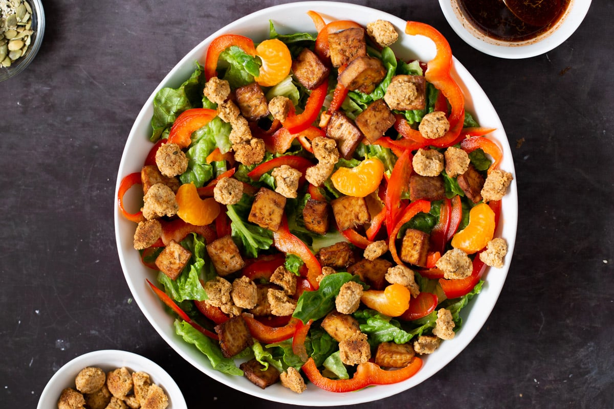 adding croutons to the salad bowl