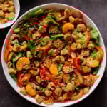 vegan summer salad in a bowl with tofu, croutons, veggies and oranges