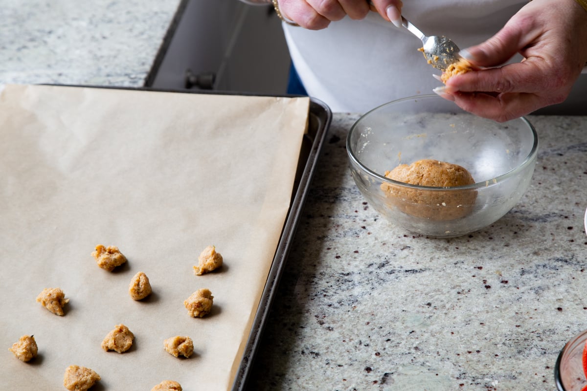 scooping almond flour croutons onto the baking sheet