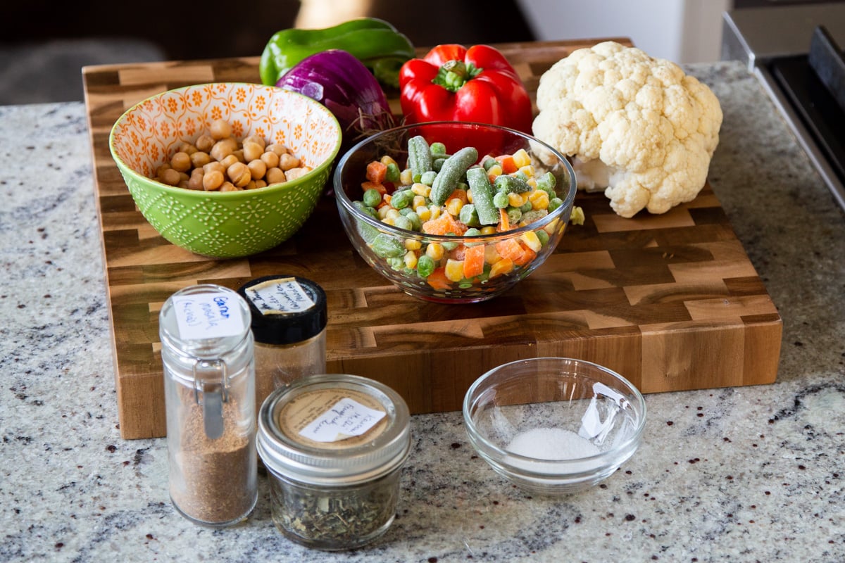vegetables, spices, and other bhuna ingredients in bowls on a kitchen counter