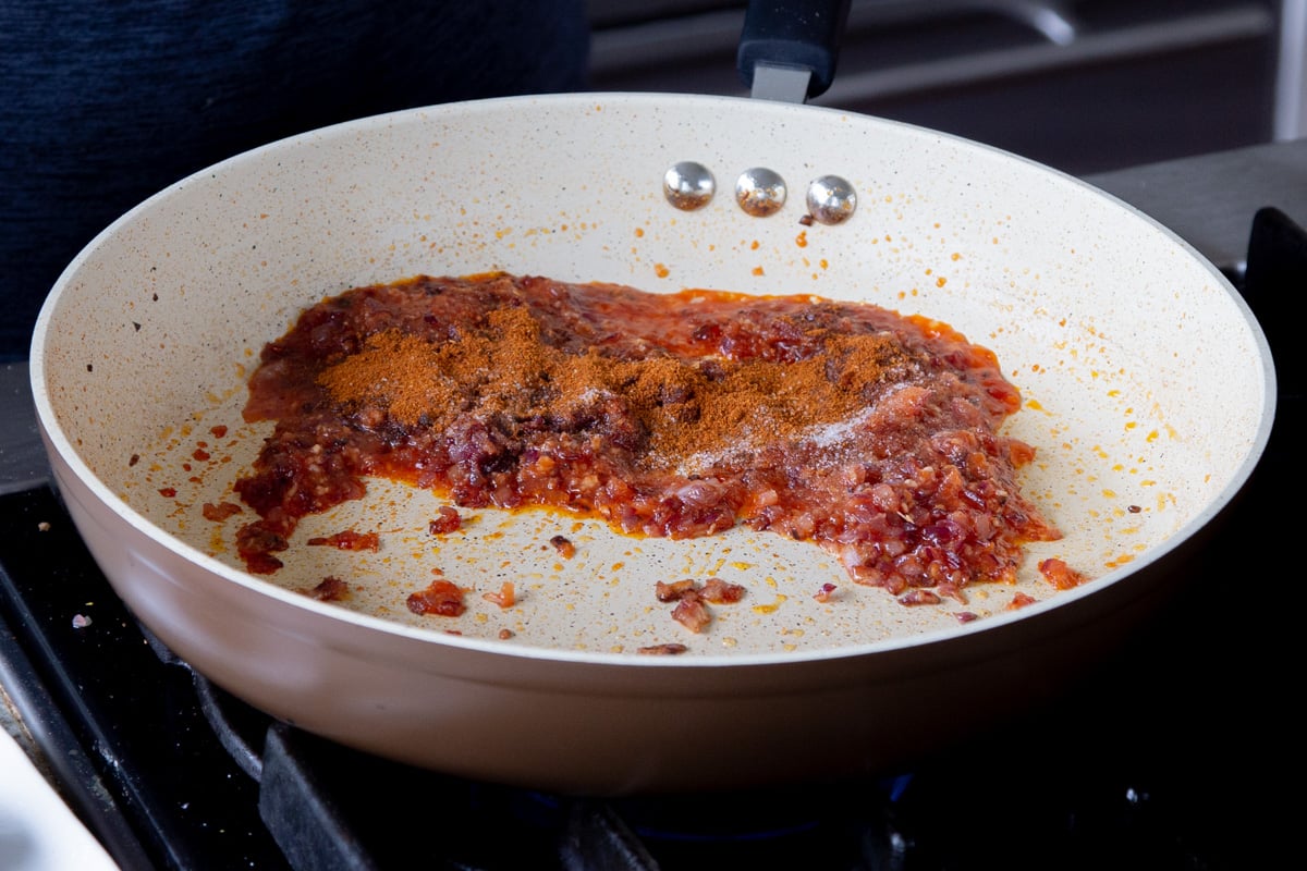 adding cajun spices to the cooked onion mixture