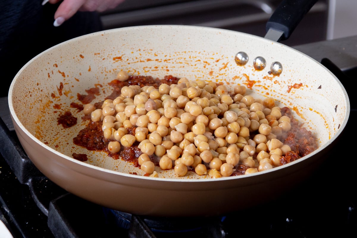 adding chickpeas to the pan