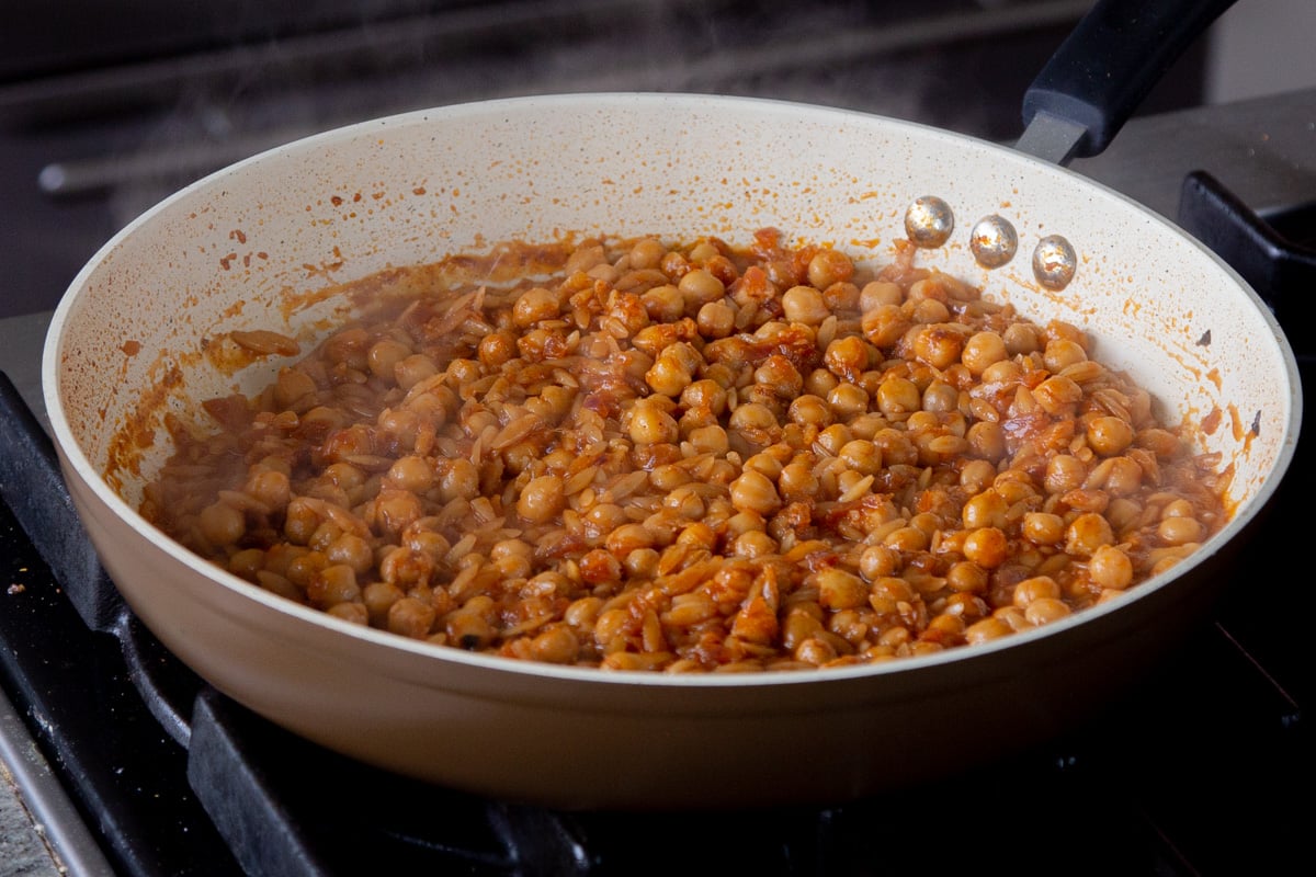 cajun orzo chickpeas in the pan after cooking