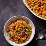 bowl of vegan cajun orzo next to the pan