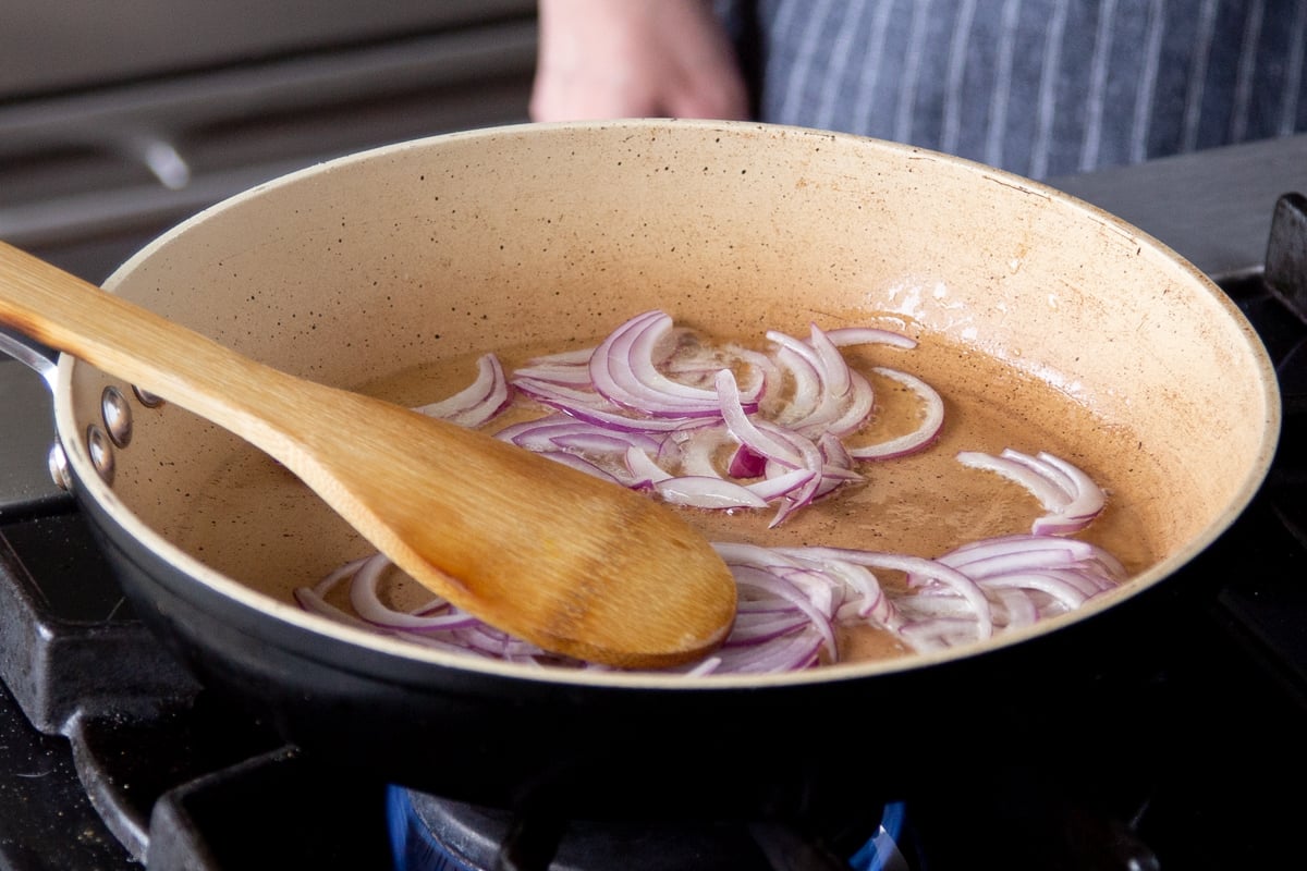 sautéing onions in the pan