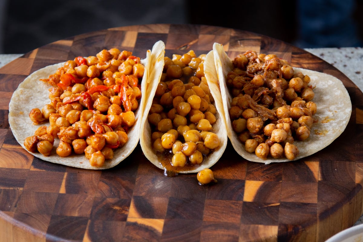 3 tortillas, one with each of the chickpea fillings, on a kitchen counter