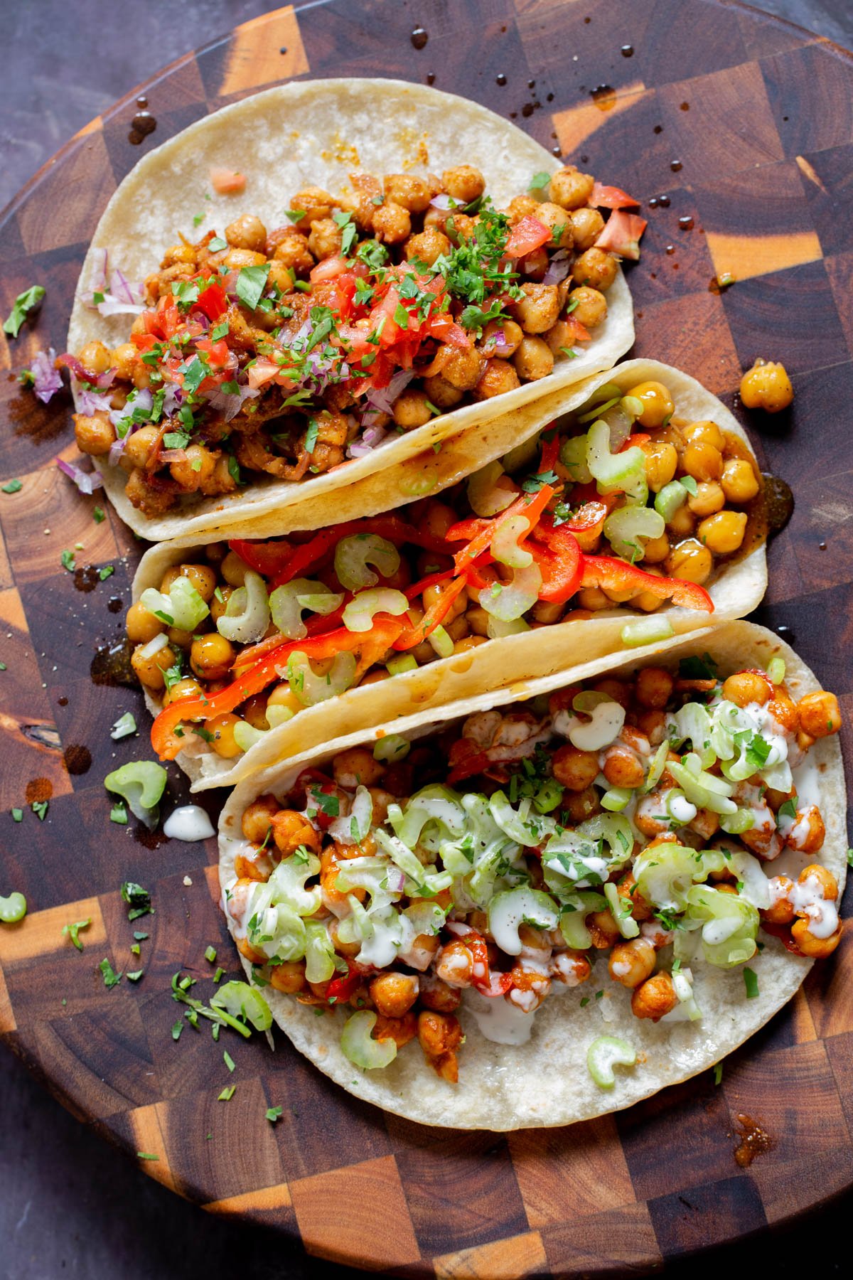 overhead photo of chickpea tacos with different fillings and toppings on the kitchen counter