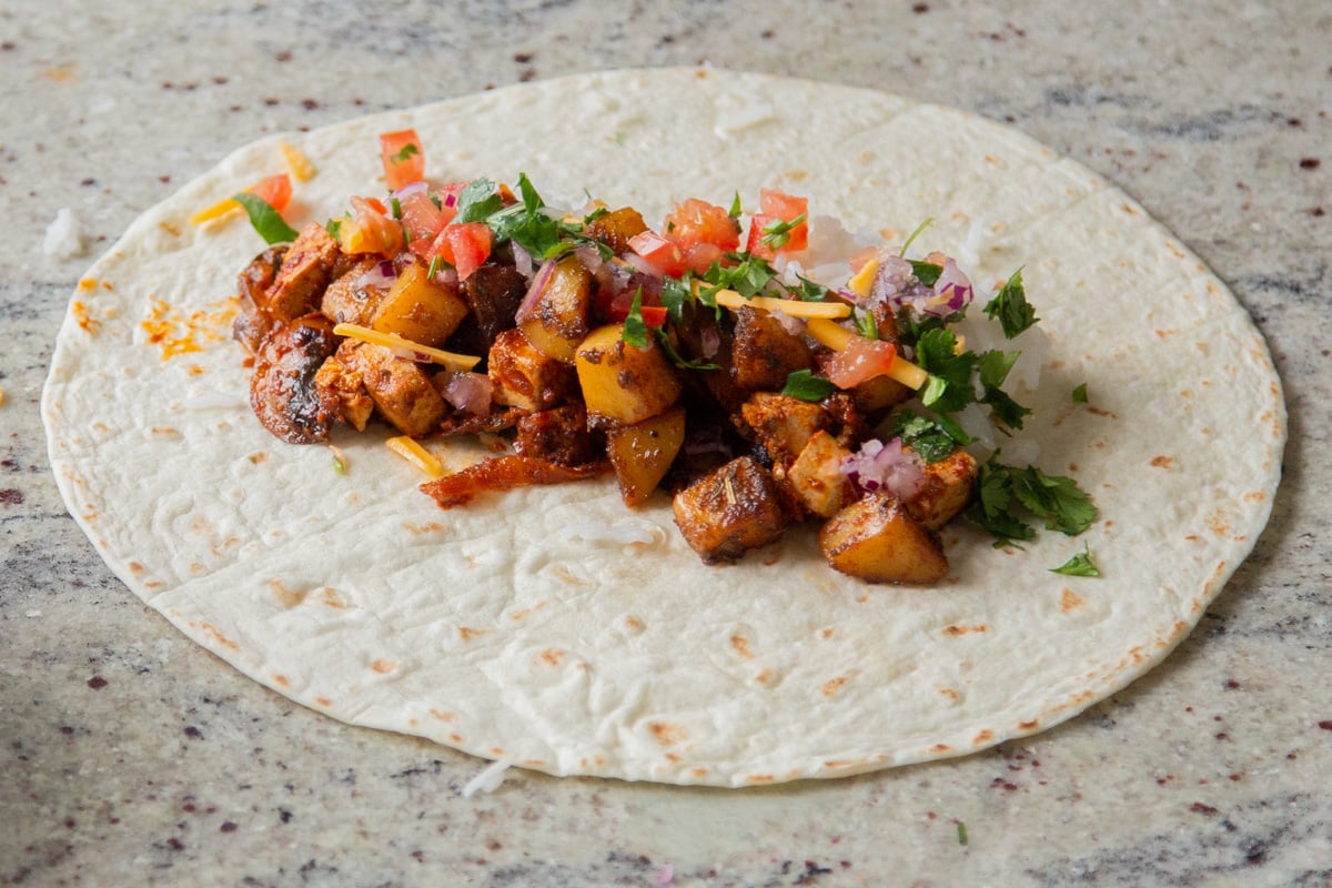 adding the rest of the burrito toppings