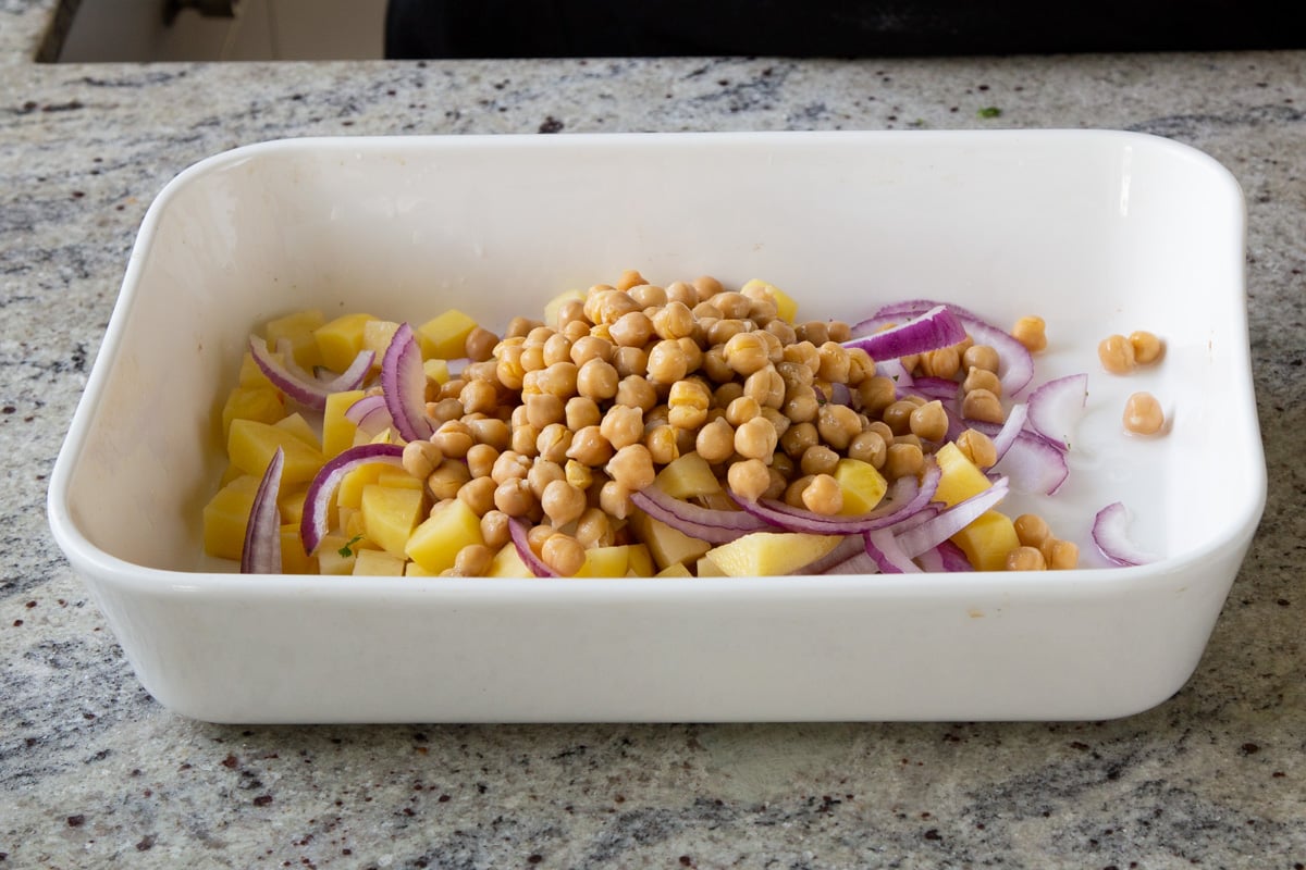 chickpeas, onions, and potatoes in the baking dish