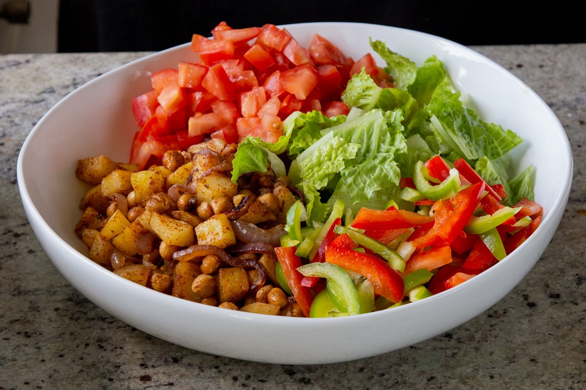 adding bell pepper to the salad bowl