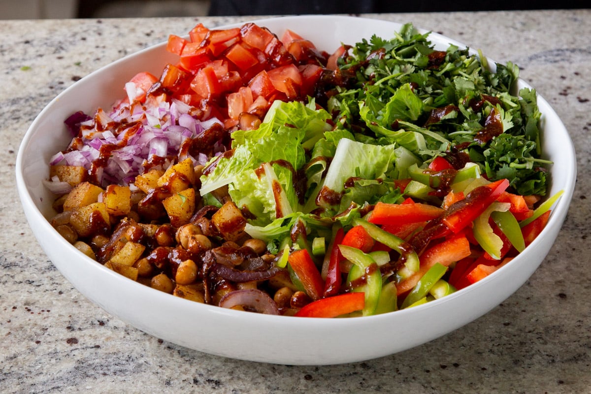 adding cilantro to the salad bowl