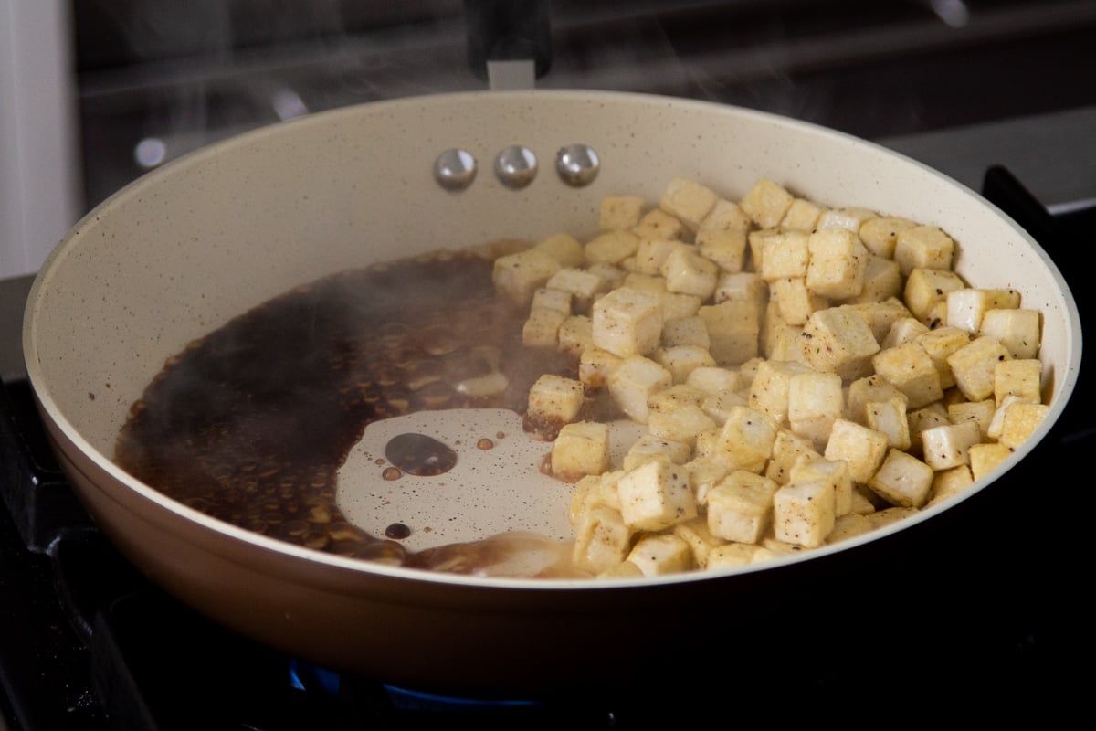 tofu moved to the side of the pan with the sauce ingredients added