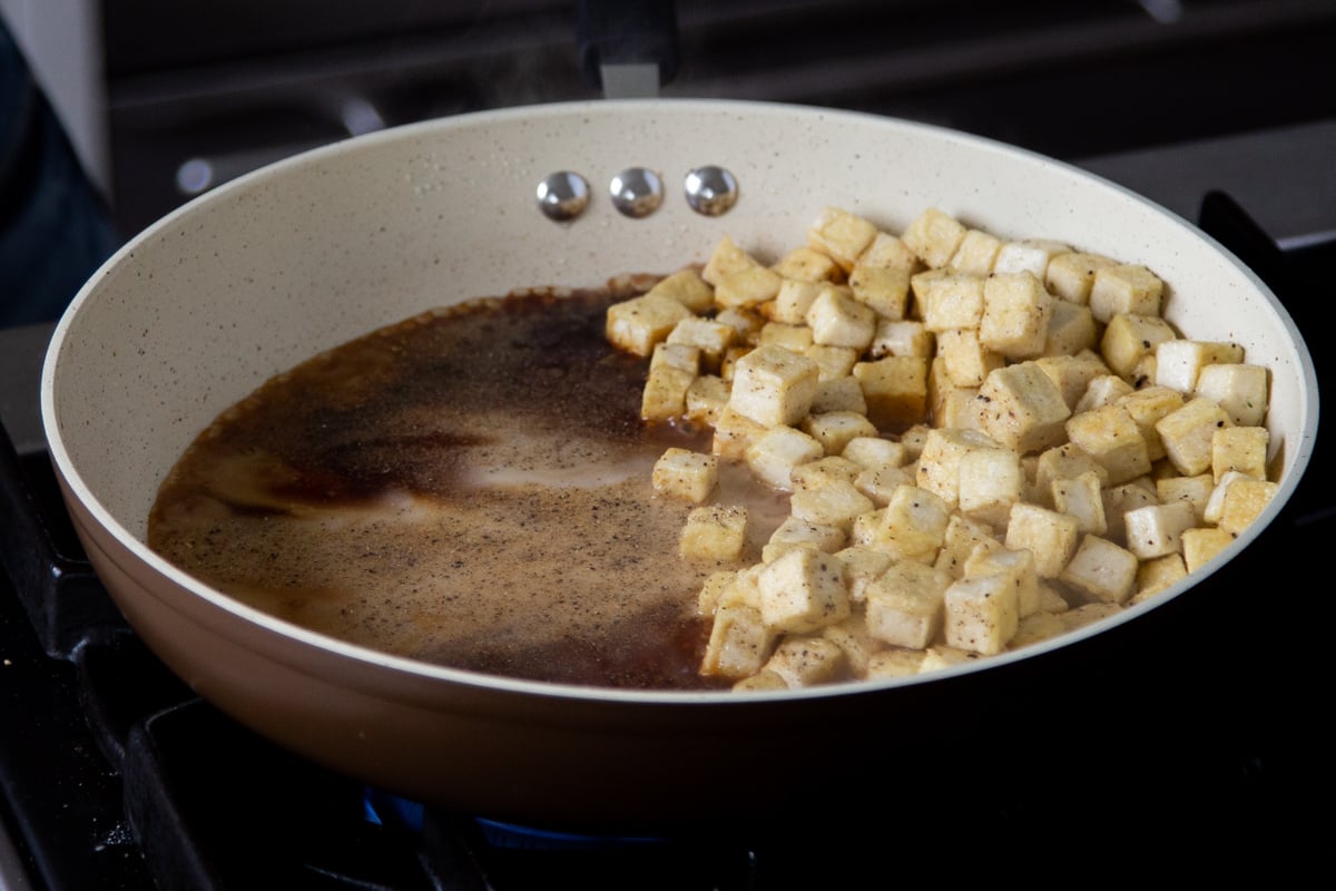 tofu moved to the side of the pan with the sauce on the other side, after thickening