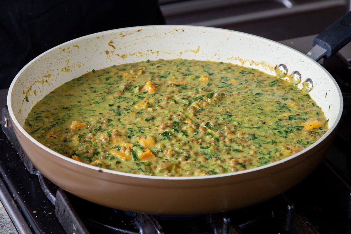 lentil coconut curry in the frying pan on the stove