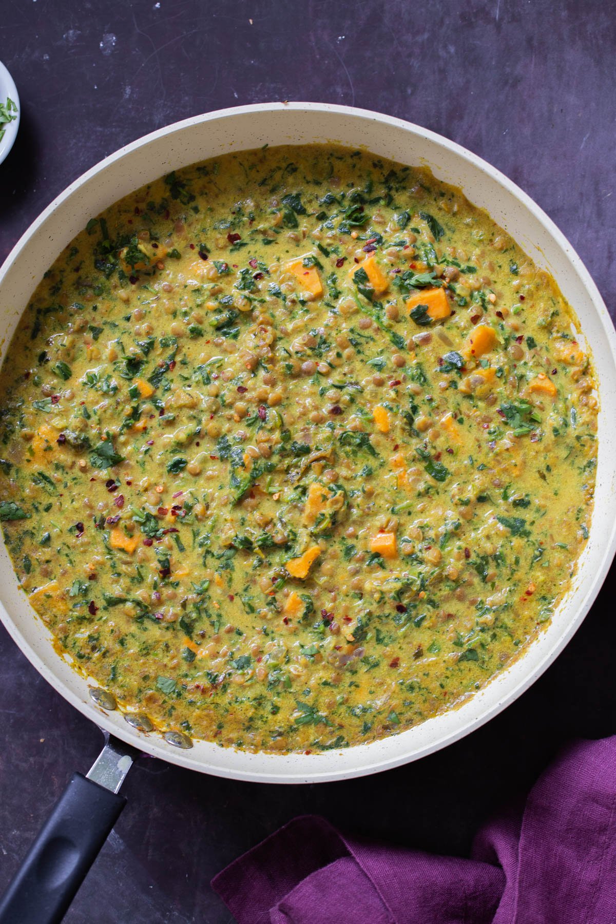 panful of lentil coconut curry on a slate table