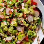 close-up of chaat masala salad in the mixing bowl with serving spoons