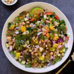 zucchini koshimbir salad in a serving bowl with a lime wedge