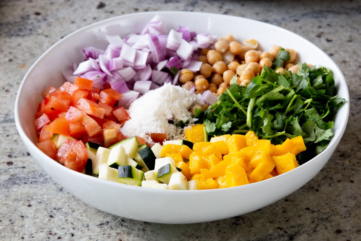mango, cilantro, and coconut added to the bowl