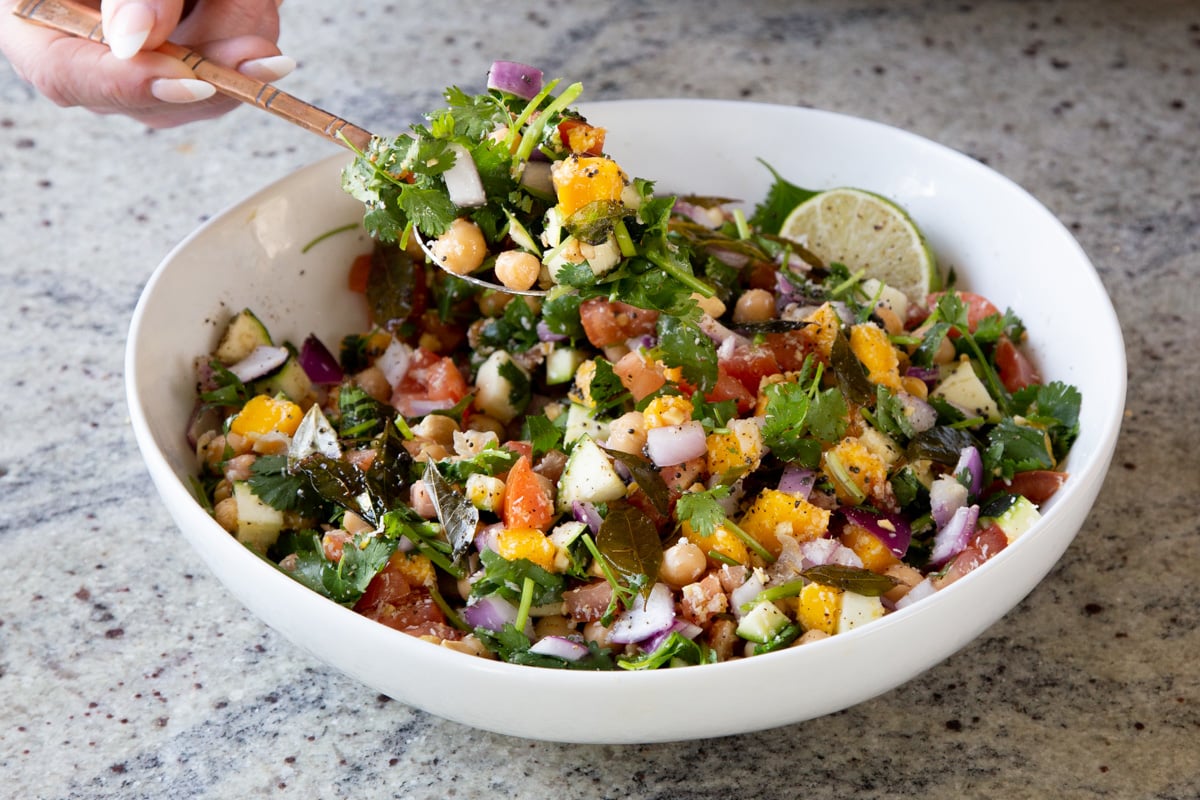 scooping up a serving spoonful of koshimbir salad